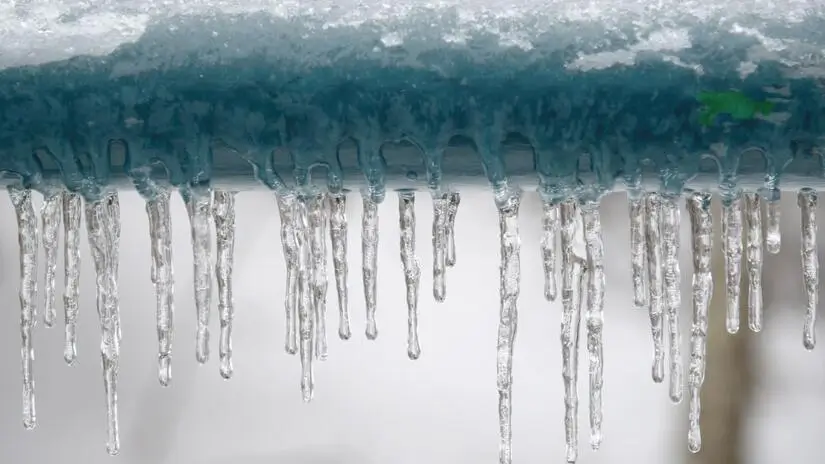 Icicles hanging from a metal hand rail